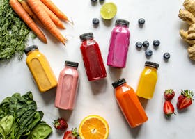 Colorful assortment of organic juices with fresh ingredients for a healthy lifestyle.